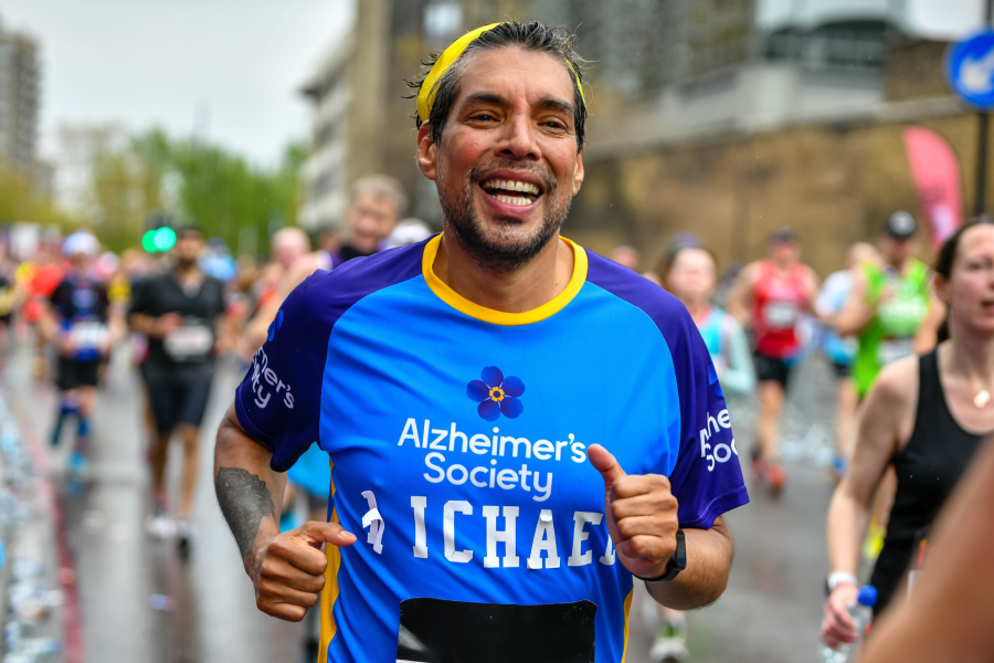 A man mid race wearing for Alzheimer's Society running top