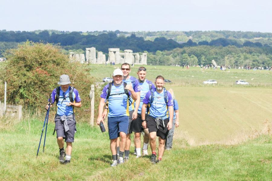 A group of trekker with Stonehenge in the backgroud