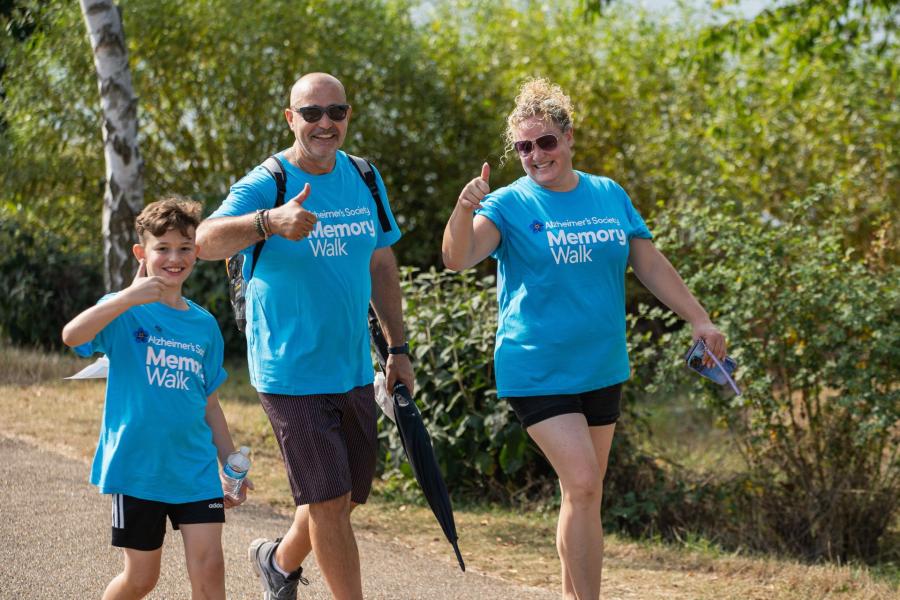 Family group in blue Memory Walk t-shirts, taking part in their own Memory Walk