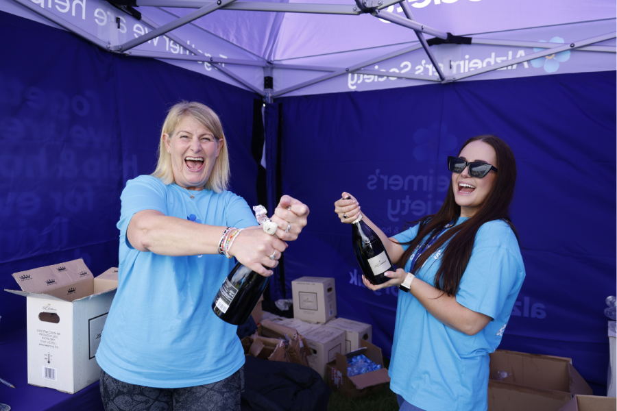 Volunteers opening bottles of bubbly at finish line 