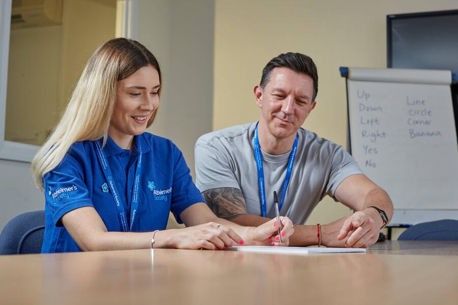 Two staff members sat at a table