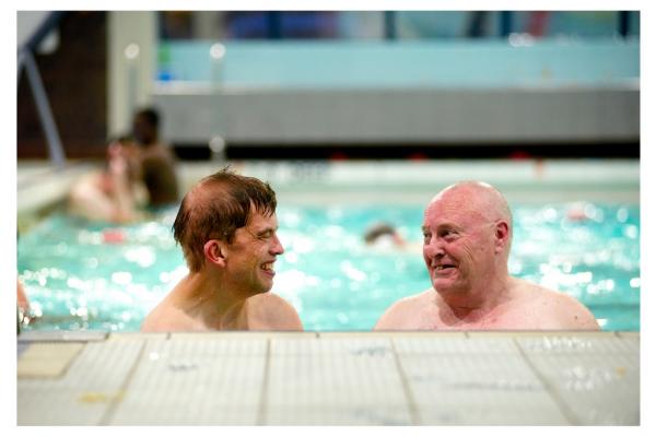 A person with dementia and a volunteer go swimming