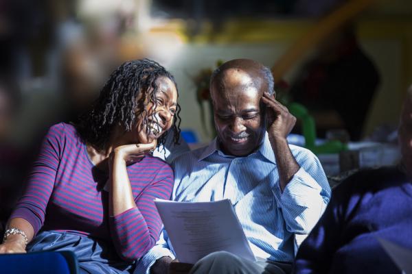 A couple reading a printed publication