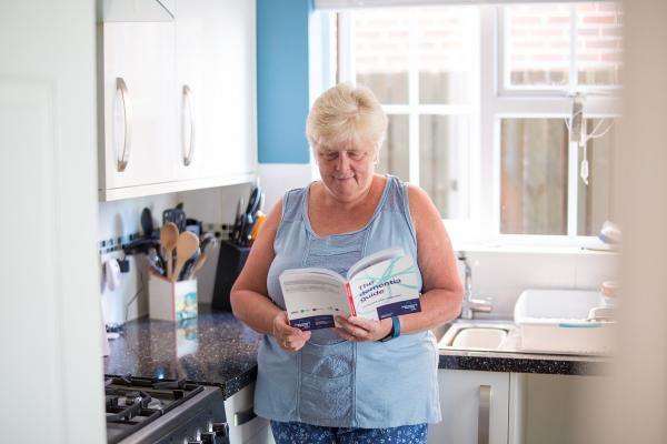 A person with dementia reads the Dementia Guide