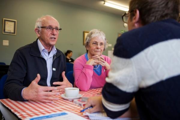 Dementia Support Officer speaking to two people