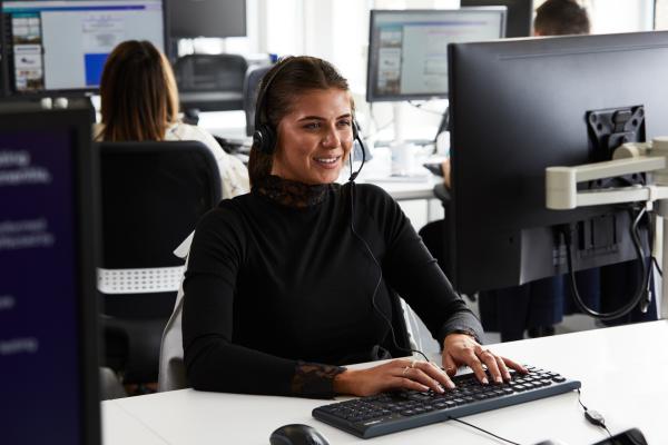 Alzheimer's employee sat at office desk working on a computer