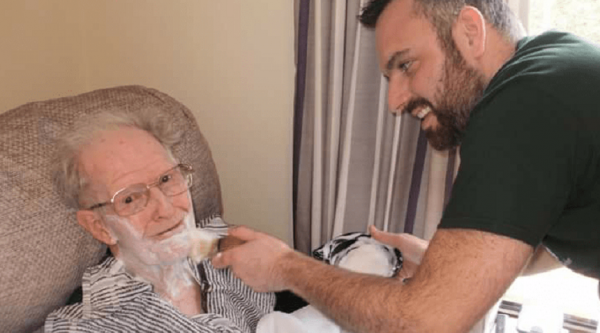 Lenny the dementia-friendly barber shaves a man in a care home