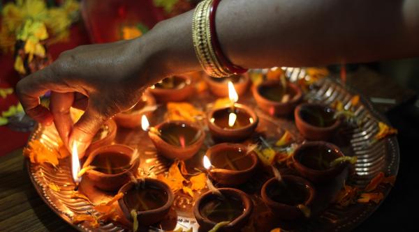 Lighting candles for Diwali