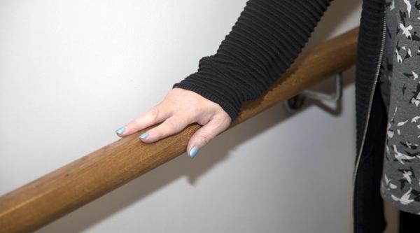 A person supporting themselves with a hand rail
