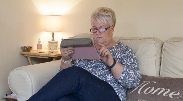Woman looking at tablet iPad - dementia information