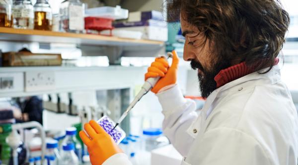 Researcher pipetting at UK DRI