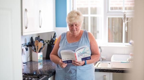 A person with dementia reads the Dementia Guide