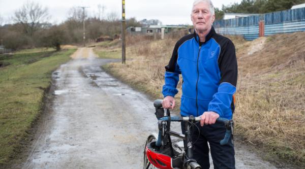 Man with a bike in a quiet road