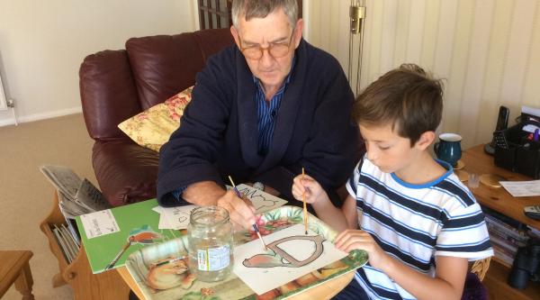 Keith painting with his grandson