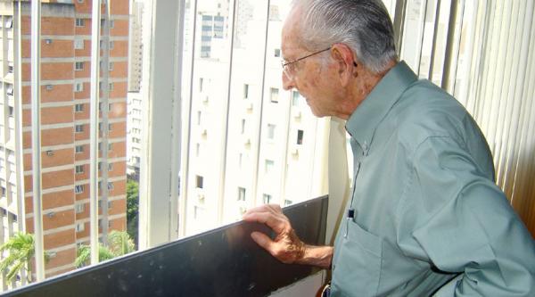 Older man looking out a window
