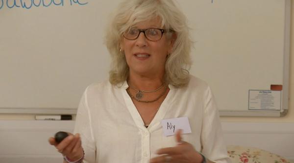 Aly Dickinson speaking at an event.