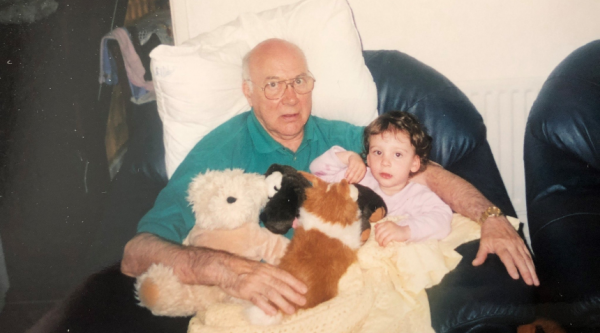 Olivia Fairhurst as a child sitting in the lap of her grandfather, Robert