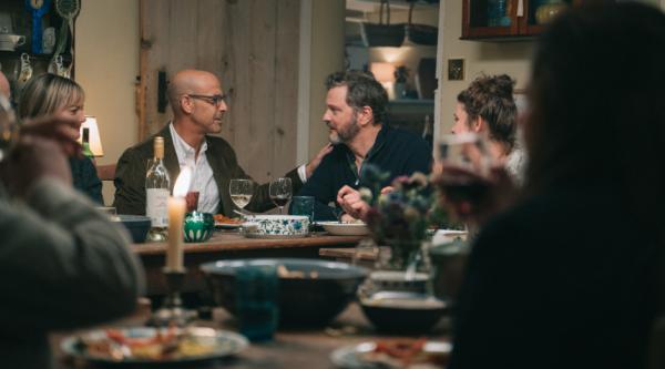 Actors Colin Firth and Stanley Tucci at a dinner party during Supernova