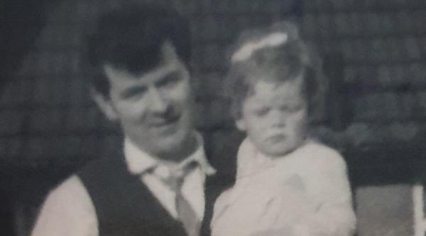 Loraine Conway as a young child being carried by her father Martin, pictured in a black and white photo