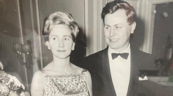 A black and white photo of Sarah's parents in 1964 wearing formal attire