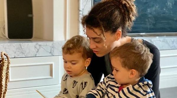 Dr Natalie Marchant reading a book to her two children
