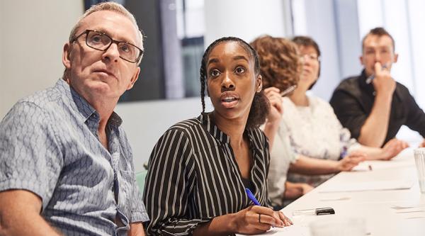 People sat at an Alzheimer's Society training course.