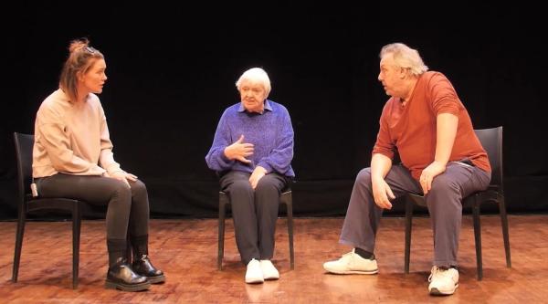3 people on stage in a play