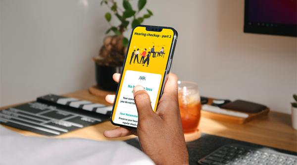 A person uses the Eargym app on a smartphone
