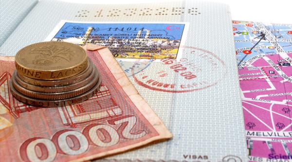 Travel money, passport and map