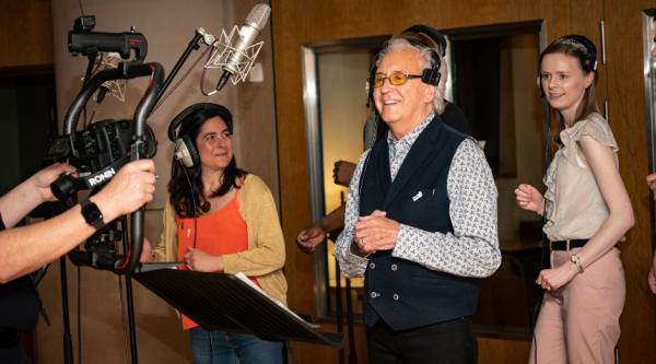 Tony Christie with two carers of people with dementia during a music recording