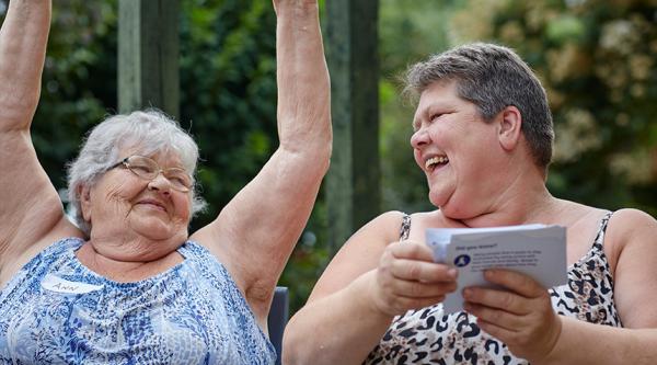 Two people affected by dementia test out exercises from the Feel Good Folder
