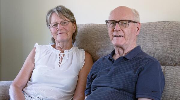 Liz and Jim Rose sat together on their lounge sofa