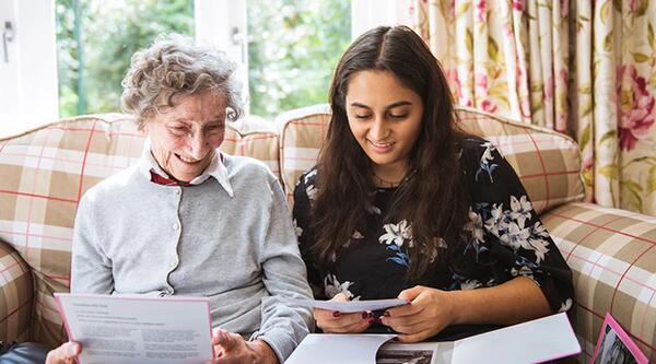 Two people looking at paperwork and photos