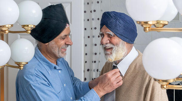 Man helping his father with his tie
