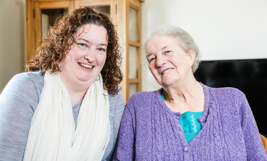 A carer smiling with a person with dementia