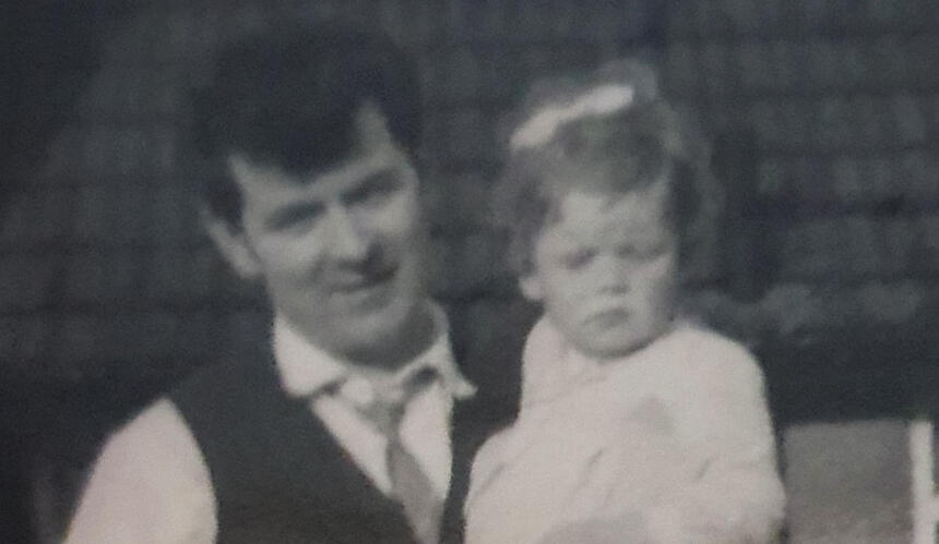 Loraine Conway as a young child being carried by her father Martin, pictured in a black and white photo