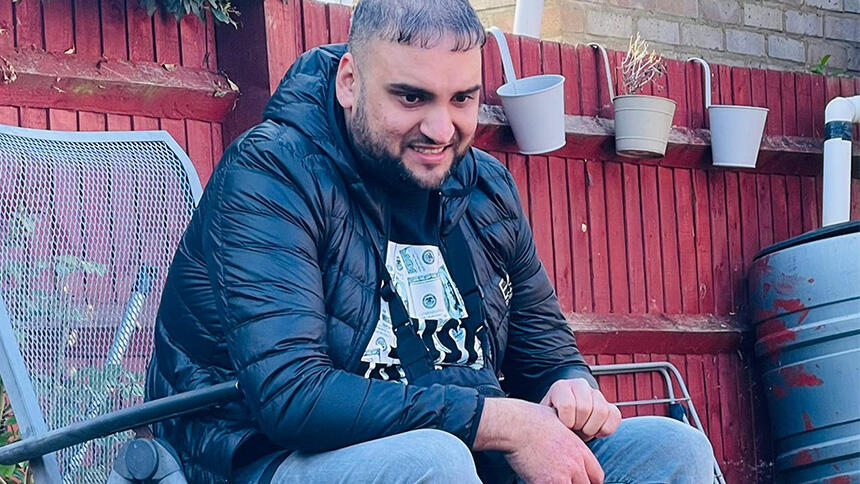 Uamar Khan sitting outside.