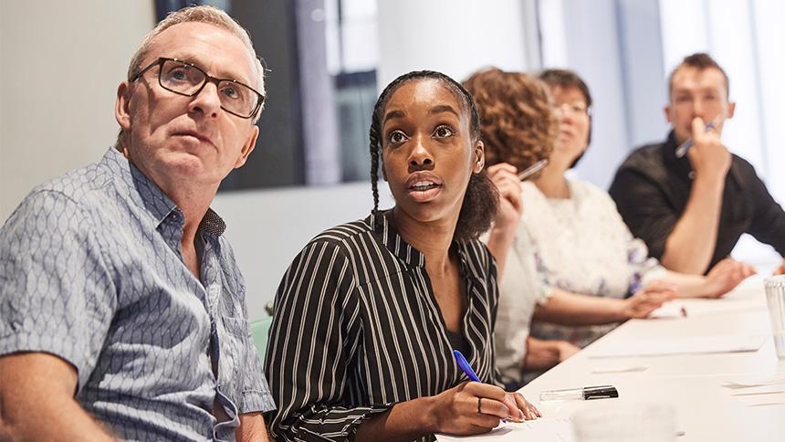 People sat at an Alzheimer's Society training course.