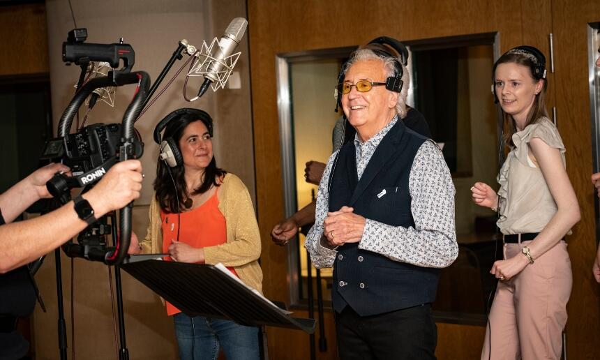 Tony Christie with two carers of people with dementia during a music recording