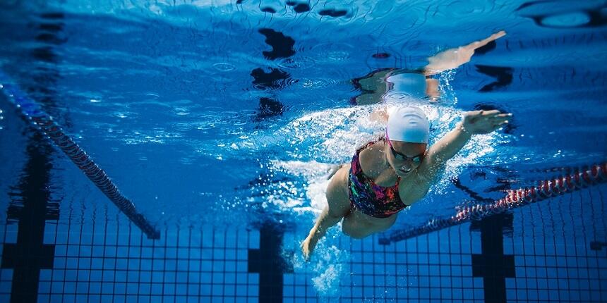 Lady swimming front crawl in a pool