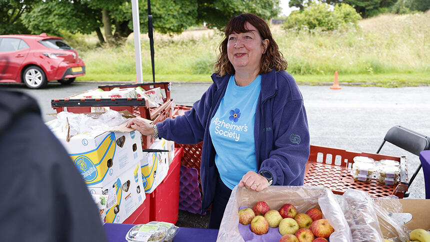 Caroline hands out food at a Trek26 event