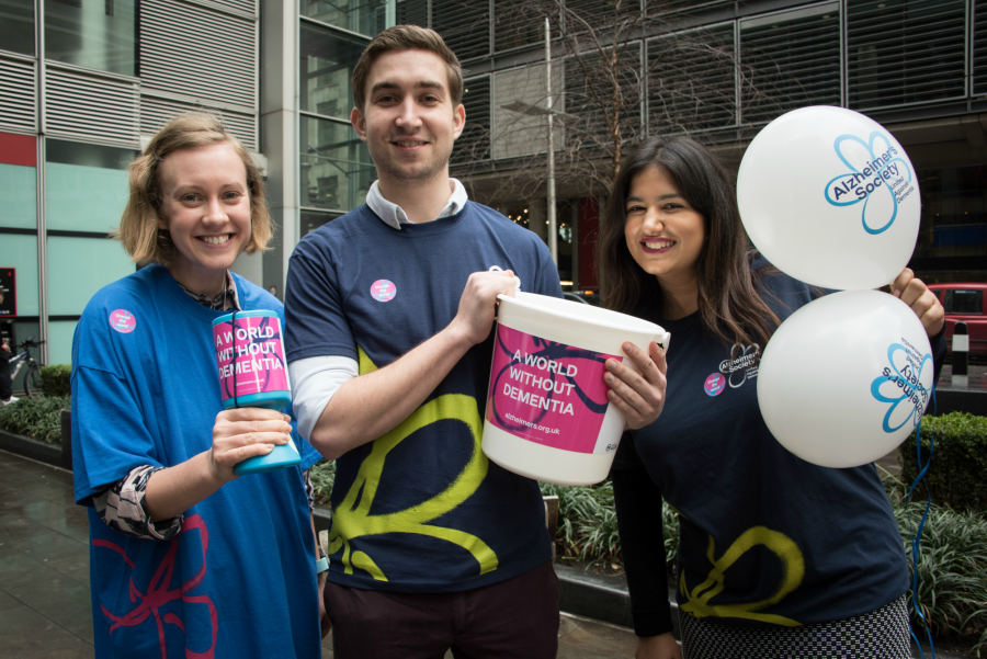 Three Alzheimer's Society fundraisers with balloons and bucket collections 