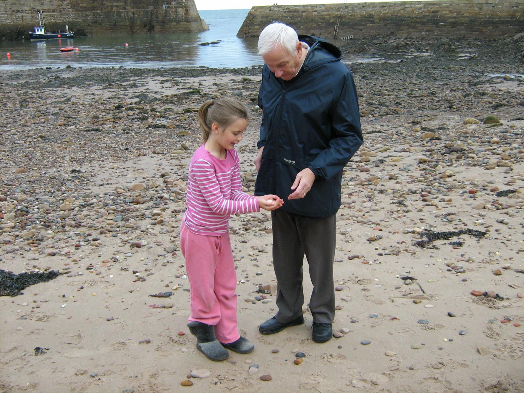 Sylvie with Grandad Owl on a beach