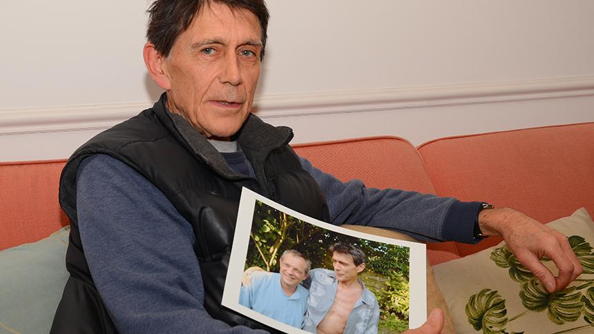 Nicky Stephens holding a photo of his late husband Carlo