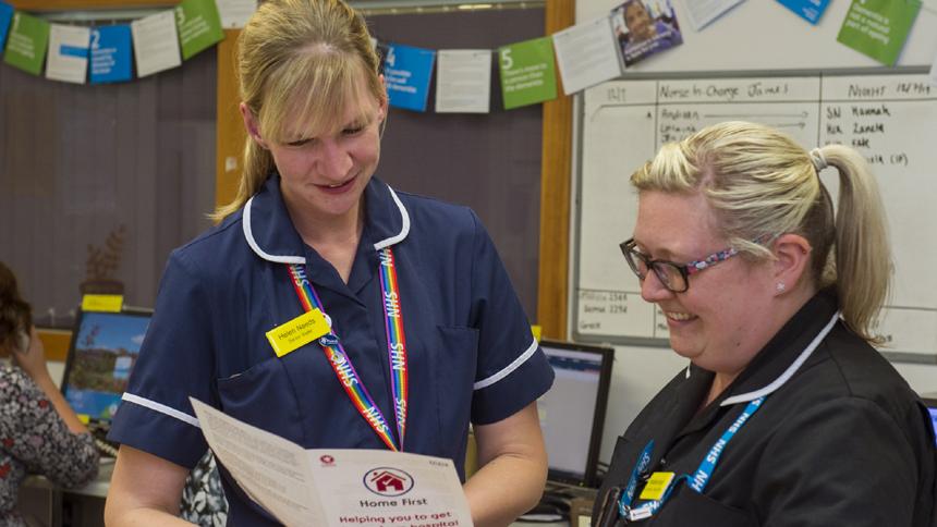Staff at Musgrove Park Hospital looking at Home First information