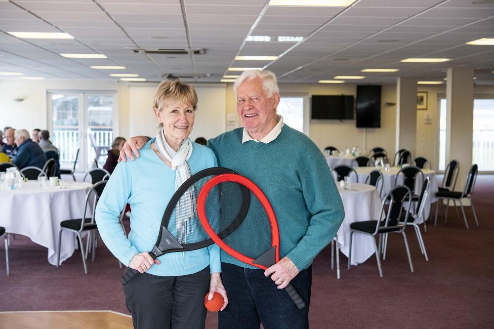 Two people with tennis rackets