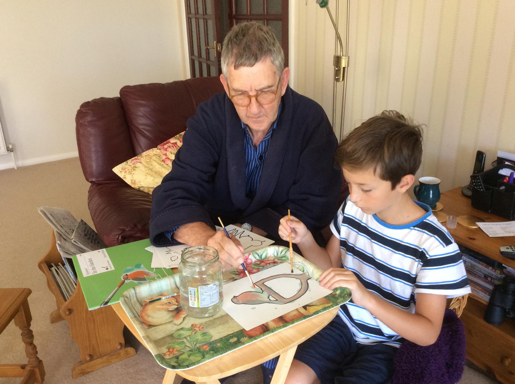 Keith painting with his grandson