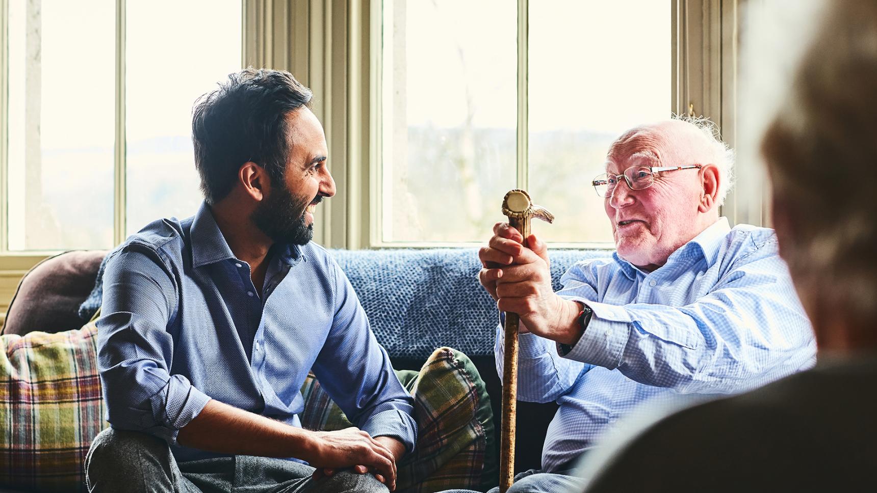 Carer supports elderly man with dementia