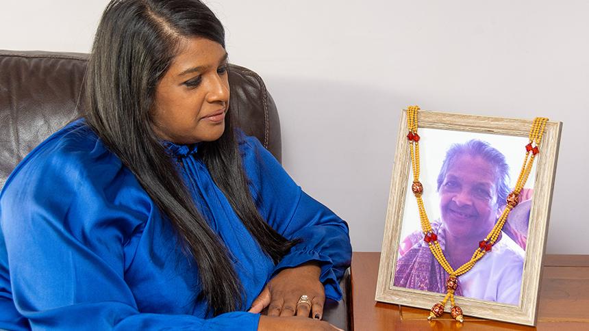 Versha Patel looking at a photo of her late mother.