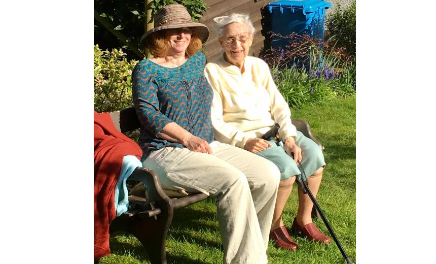 Janet and her mother, Doris, sitting on a bench